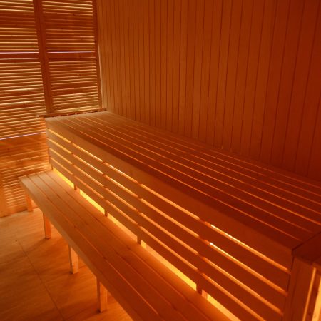 Interior of small home wooden sauna. Wooden benches